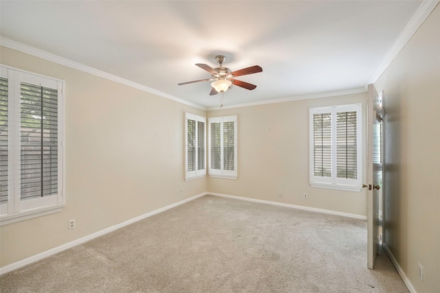 carpeted empty room with ornamental molding and ceiling fan