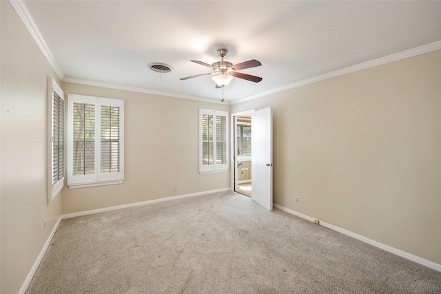 spare room featuring ornamental molding, light carpet, and ceiling fan