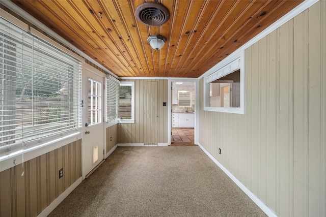 unfurnished sunroom featuring wooden ceiling