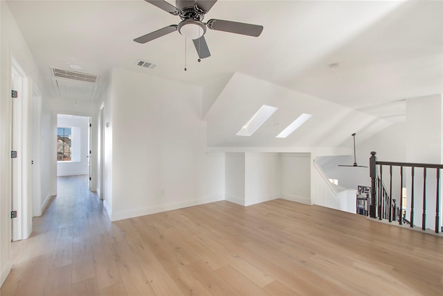 additional living space featuring ceiling fan, lofted ceiling, and light hardwood / wood-style flooring