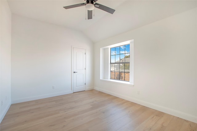 spare room with lofted ceiling, ceiling fan, and light hardwood / wood-style flooring