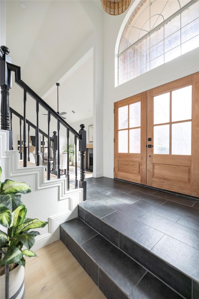 foyer with a towering ceiling and french doors