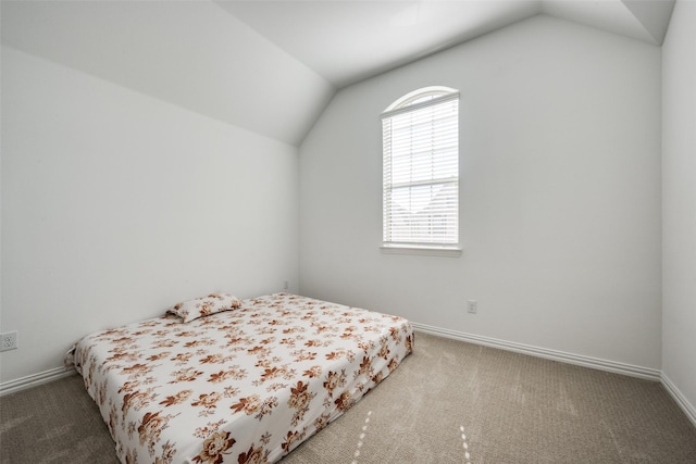 bedroom featuring lofted ceiling and carpet flooring