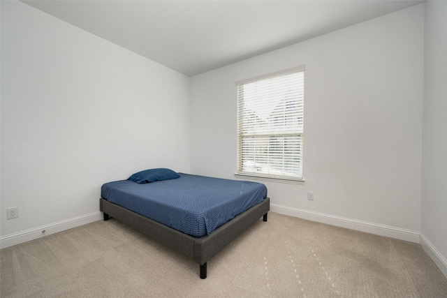 bedroom with light colored carpet