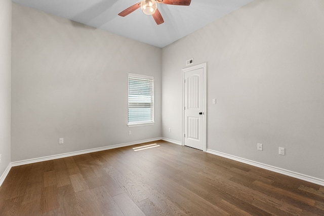 spare room featuring dark wood-type flooring and ceiling fan