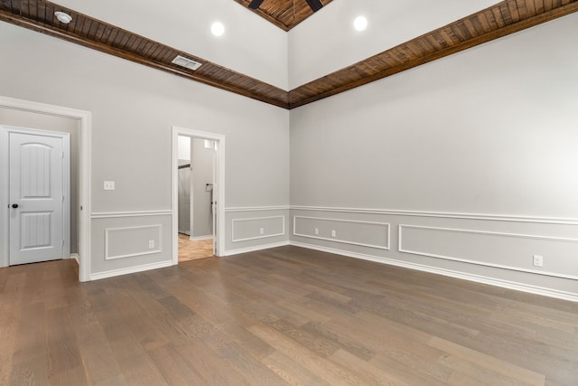 unfurnished room with hardwood / wood-style floors and wood ceiling