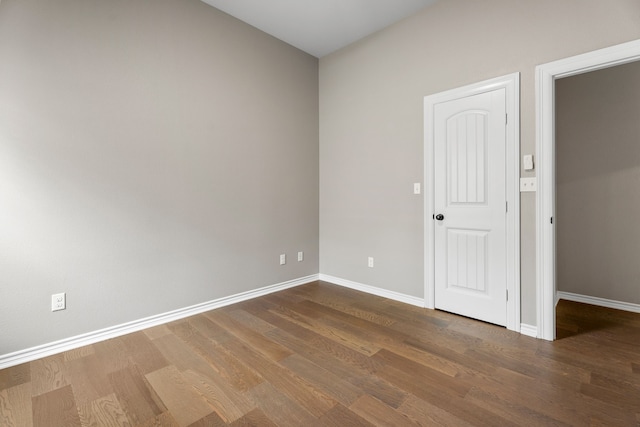 spare room with dark hardwood / wood-style flooring