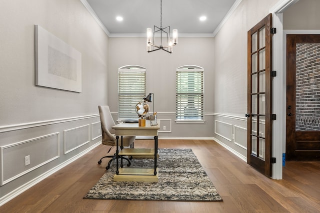 office area featuring crown molding, a notable chandelier, and hardwood / wood-style flooring