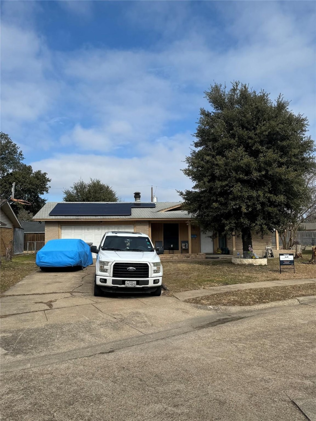 view of front facade with solar panels