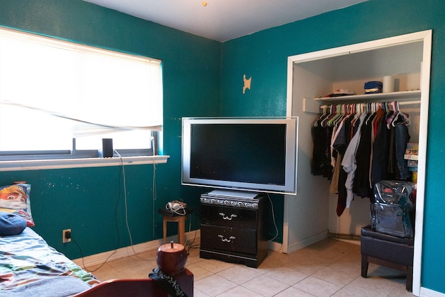 bedroom featuring light tile patterned flooring and a closet