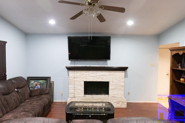 living room featuring a fireplace, dark hardwood / wood-style floors, and ceiling fan