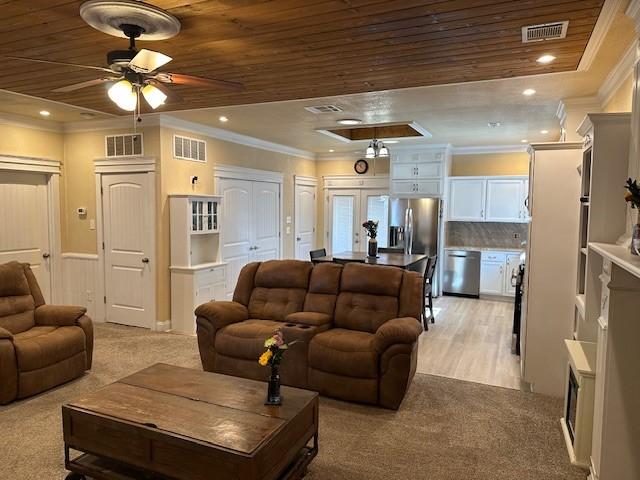 living room featuring ornamental molding, light colored carpet, and wood ceiling