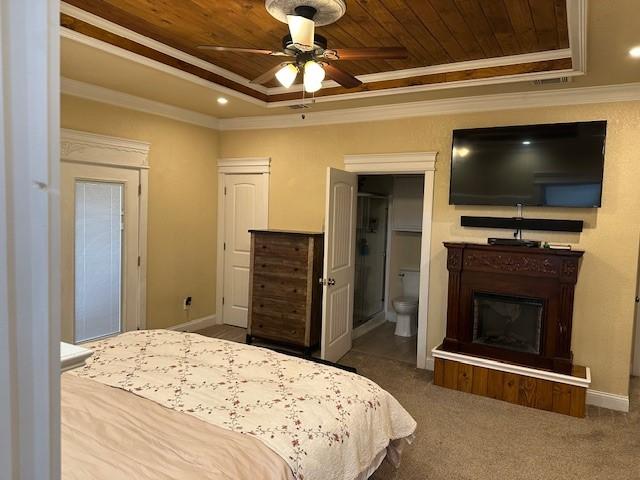 bedroom with crown molding, ceiling fan, wood ceiling, and a tray ceiling