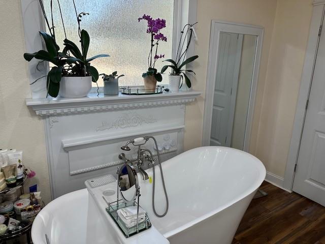 room details featuring wood-type flooring and a bathtub