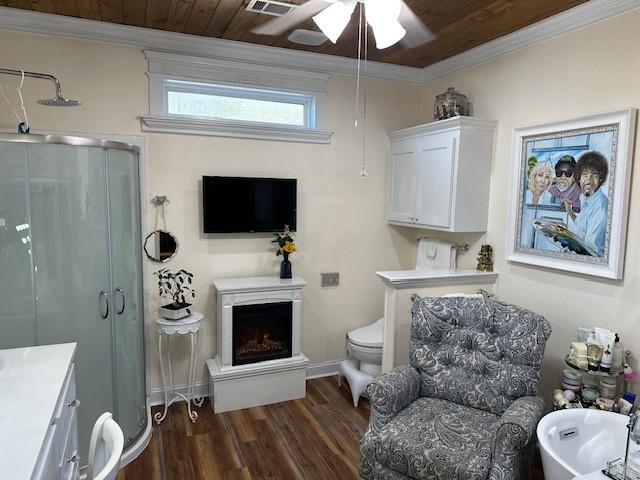 living area with ornamental molding, wooden ceiling, dark hardwood / wood-style floors, and ceiling fan