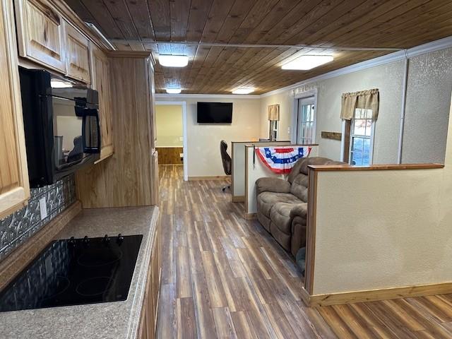 kitchen with light brown cabinetry, wood ceiling, black appliances, crown molding, and dark wood-type flooring