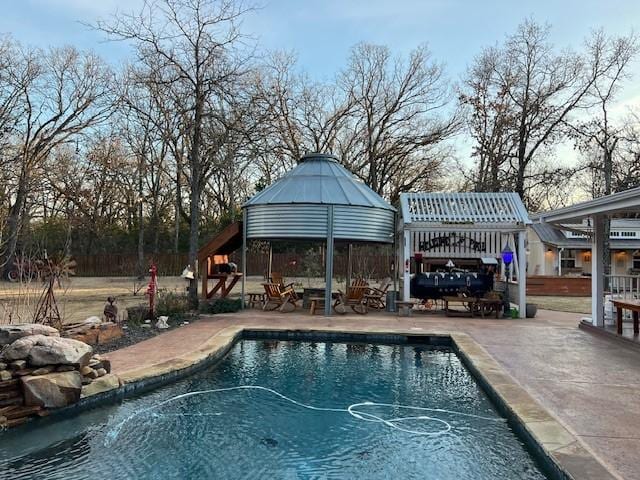 view of swimming pool featuring a gazebo and a patio