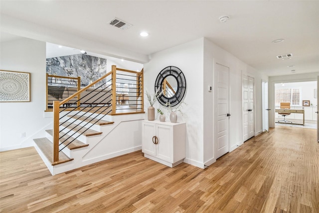 interior space with recessed lighting, wood finished floors, visible vents, and baseboards