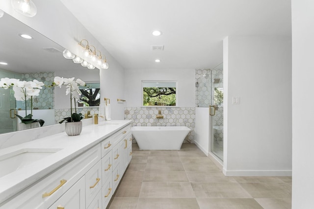 full bath with a sink, a freestanding tub, double vanity, and a shower stall