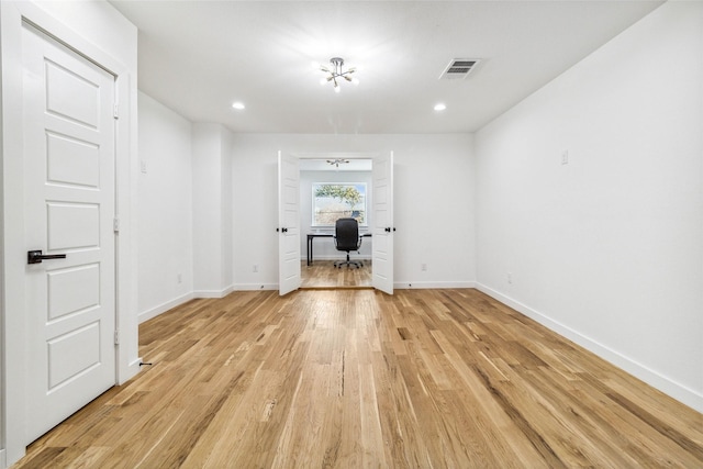 spare room featuring light wood-type flooring