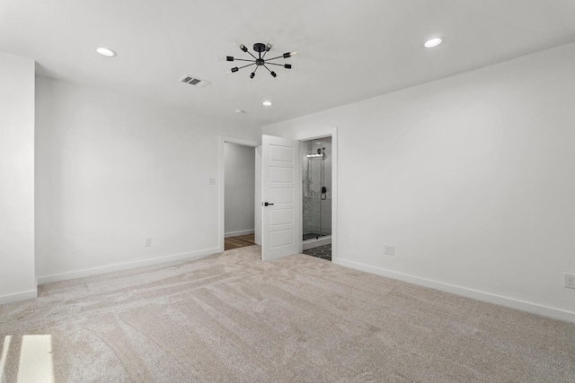 carpeted spare room with recessed lighting, visible vents, and baseboards