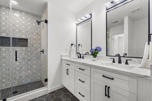 bathroom with tile patterned floors, a shower with shower door, and vanity