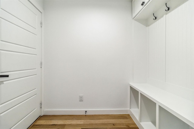 mudroom with light wood finished floors and baseboards