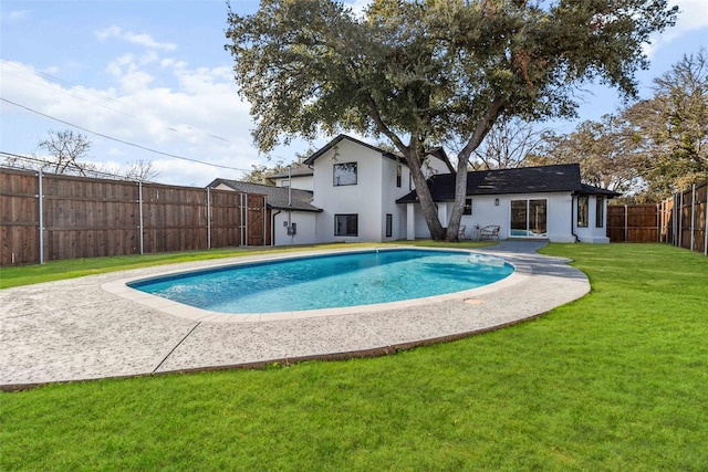 view of pool with a patio area, a lawn, a fenced in pool, and a fenced backyard