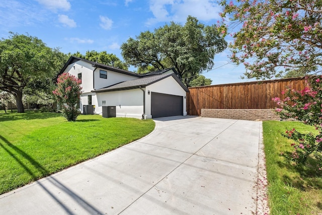 view of home's exterior featuring a garage, a yard, and central air condition unit