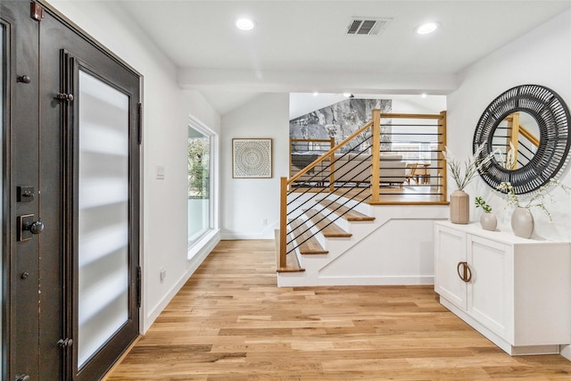 entryway with light wood finished floors, visible vents, recessed lighting, and stairway