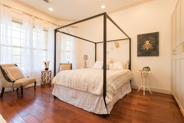 bedroom with dark hardwood / wood-style flooring