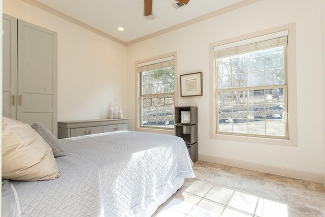 bedroom with ceiling fan, ornamental molding, and multiple windows