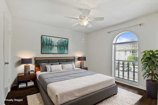 bedroom with dark wood-type flooring and a ceiling fan