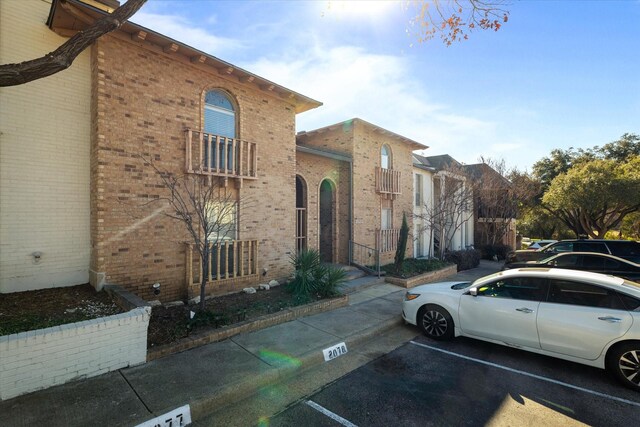 15914 Stillwood St Unit 2078, Dallas, TX 75248 - view of front of property with brick siding and uncovered parking