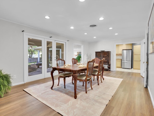 dining space featuring french doors and light hardwood / wood-style floors