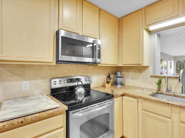 kitchen featuring tasteful backsplash, appliances with stainless steel finishes, sink, and light brown cabinets