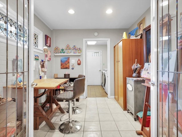 kitchen with independent washer and dryer and light tile patterned floors