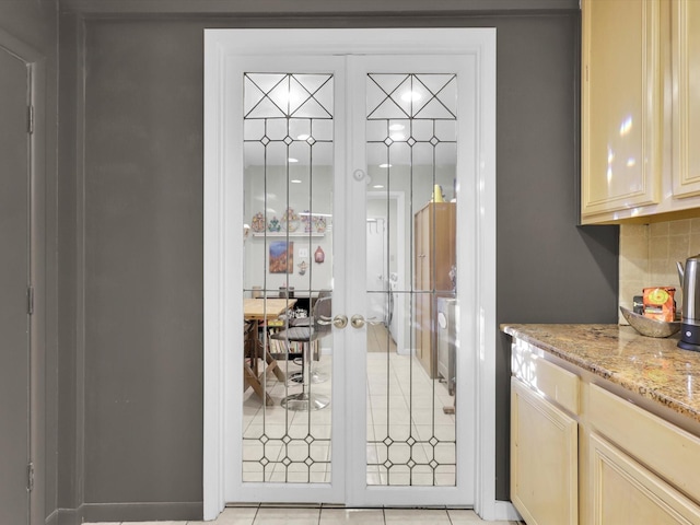 doorway with french doors and light tile patterned floors