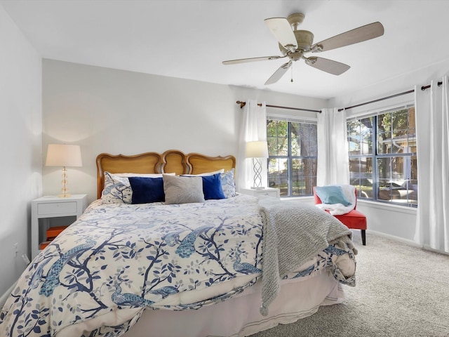 bedroom featuring ceiling fan and carpet