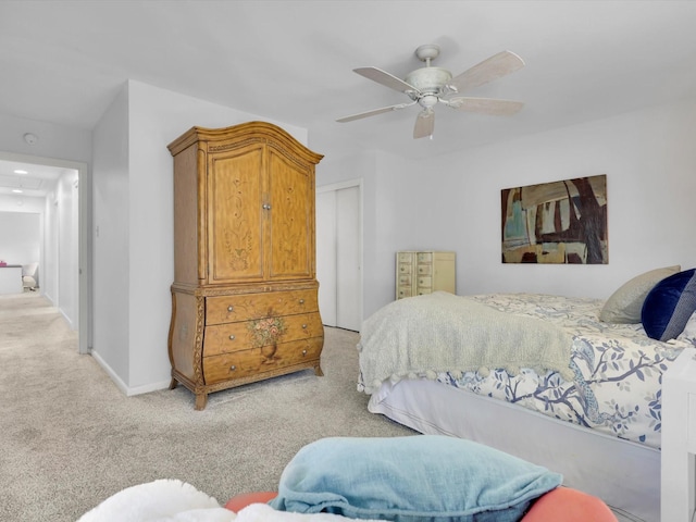 bedroom featuring light carpet, a closet, and ceiling fan