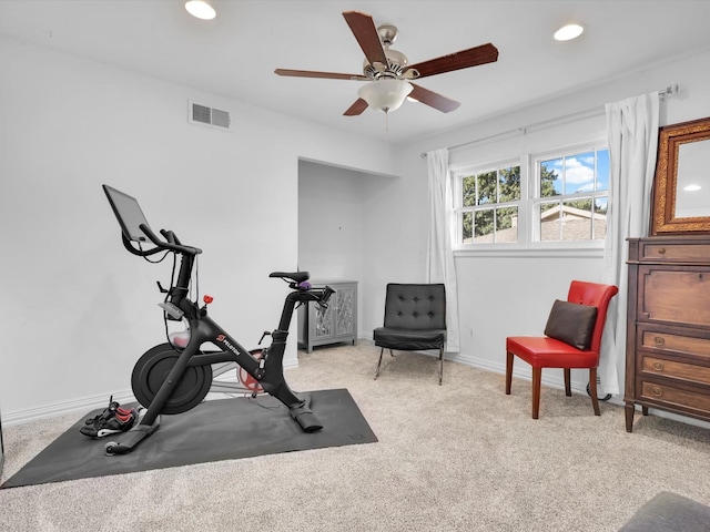 workout room with ceiling fan and light carpet