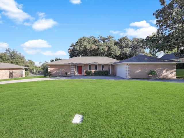 ranch-style house with a garage and a front yard