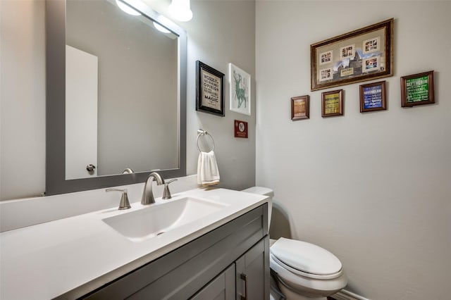 bathroom with toilet and vanity