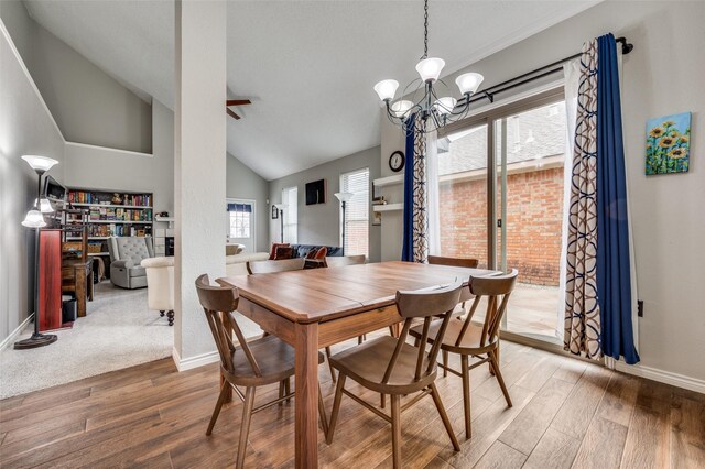 dining area featuring an inviting chandelier, wood-type flooring, and a high ceiling