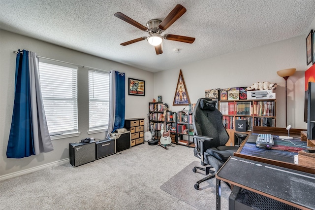 office space with a textured ceiling, carpet, a ceiling fan, and baseboards