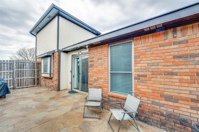 view of patio featuring fence