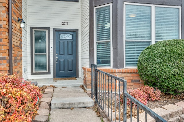 doorway to property featuring brick siding