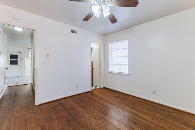 empty room featuring ceiling fan and dark hardwood / wood-style flooring