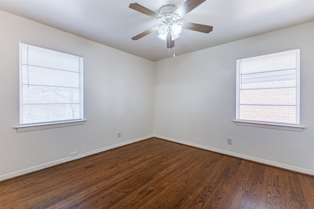 empty room with dark hardwood / wood-style floors and ceiling fan