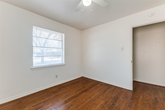 unfurnished room featuring dark hardwood / wood-style flooring, a wealth of natural light, and ceiling fan